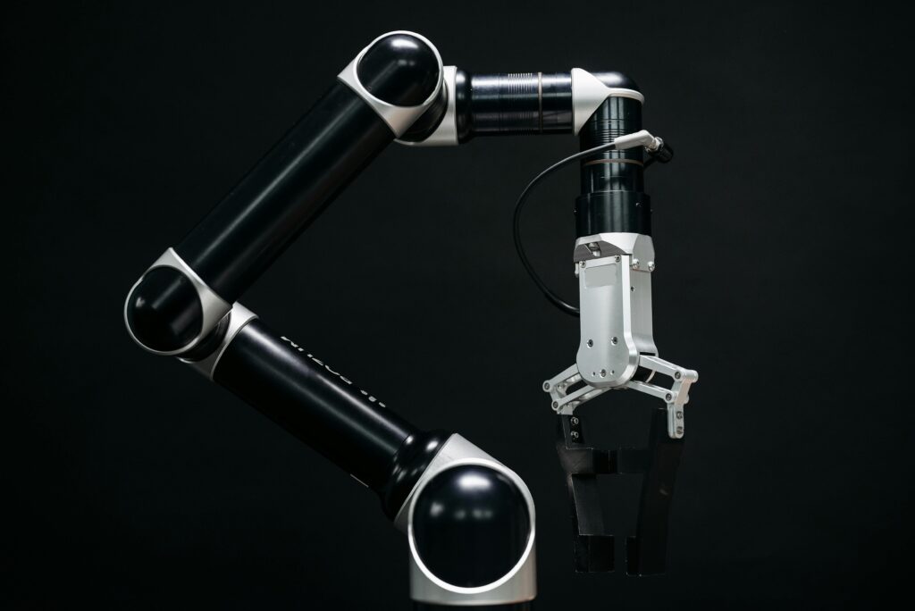 Close-up of a mechanical robotic arm with a dark background, showcasing advanced technology.